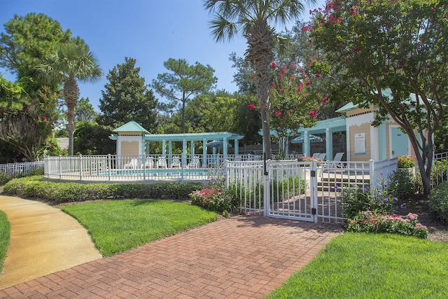 exterior space with a pergola, a lawn, and a community pool