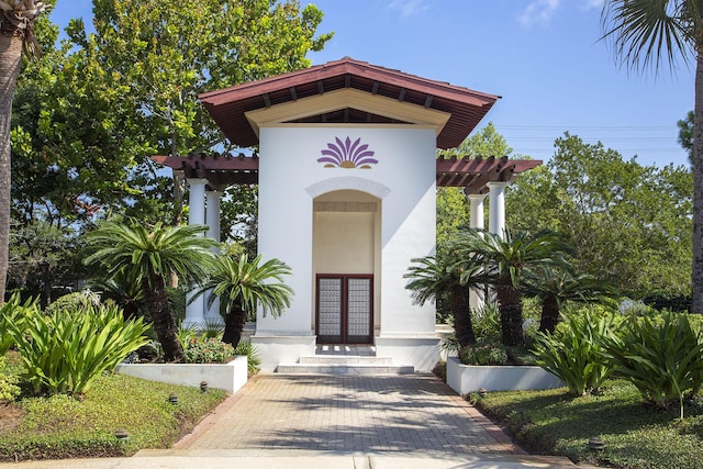 entrance to property with a pergola