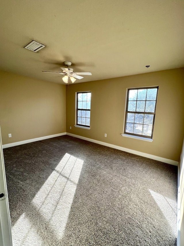 empty room featuring ceiling fan and carpet flooring