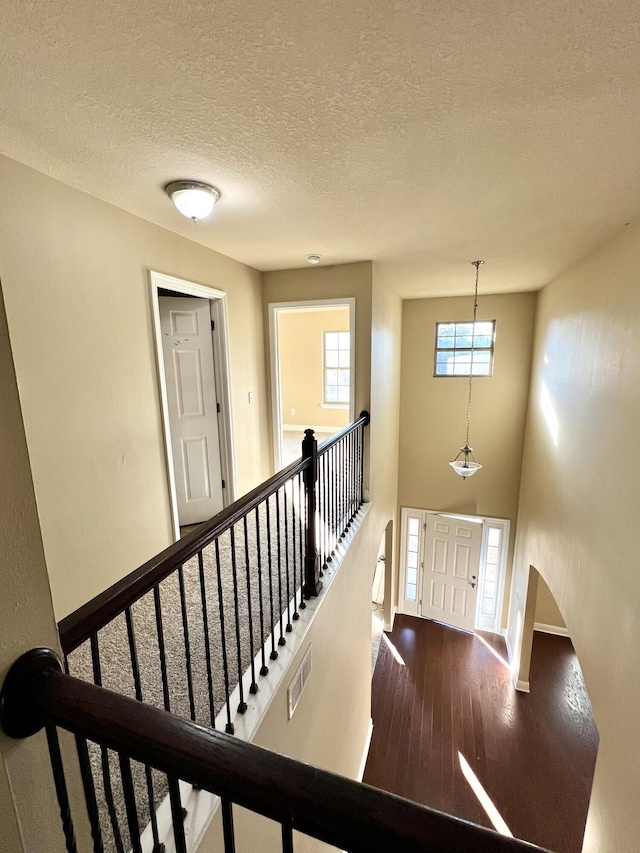 entryway with hardwood / wood-style flooring and a textured ceiling