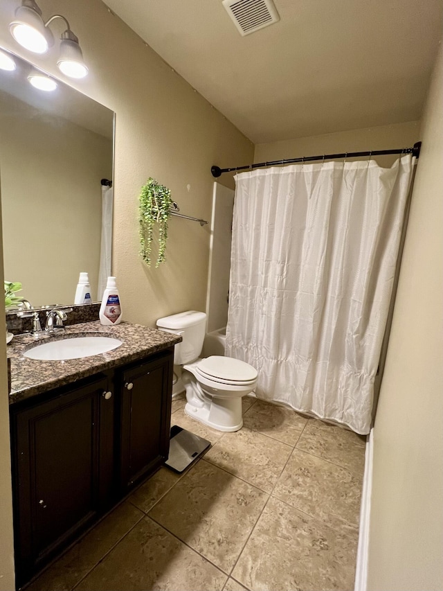 full bathroom featuring vanity, shower / bathtub combination with curtain, tile patterned floors, and toilet