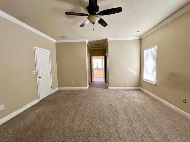 unfurnished room featuring ornamental molding, carpet floors, and ceiling fan