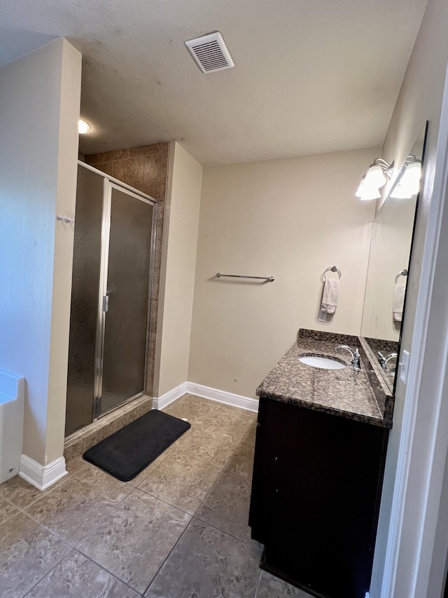 bathroom with vanity, vaulted ceiling, and a shower with shower door