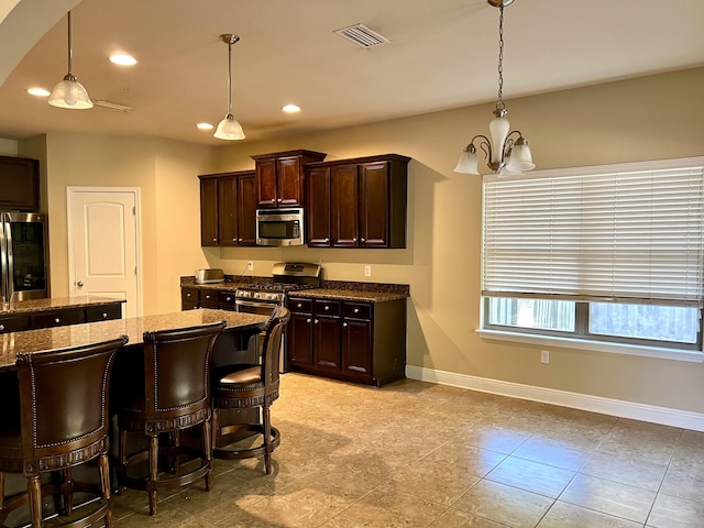 kitchen with stainless steel appliances, decorative light fixtures, and dark brown cabinets