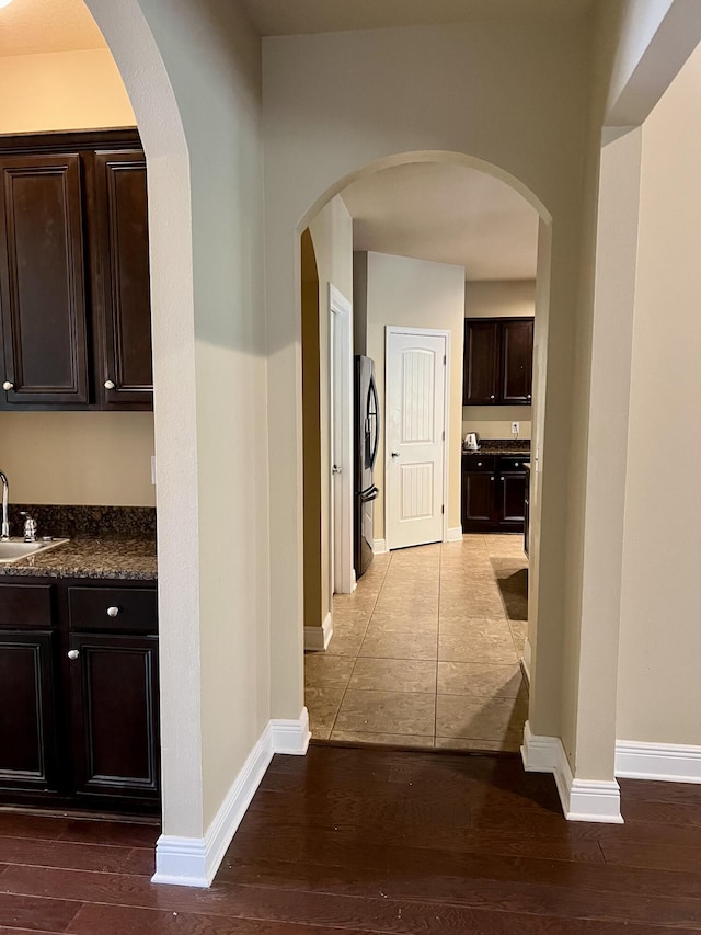 corridor with sink and hardwood / wood-style flooring