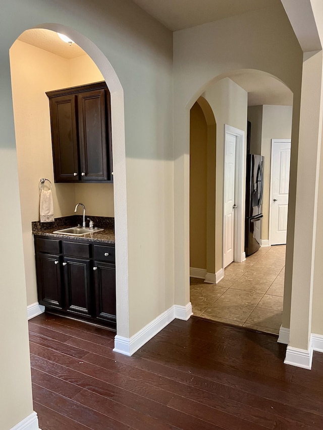 hall featuring sink and dark wood-type flooring