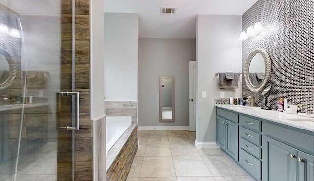 bathroom featuring tile patterned flooring, shower with separate bathtub, and vanity