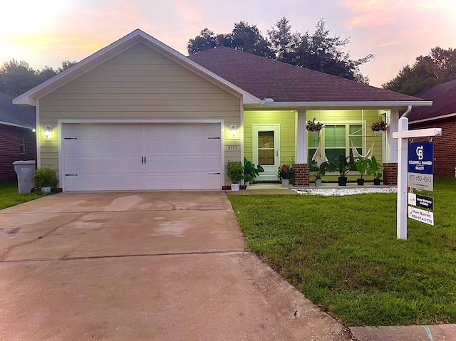 view of front of house with a yard and a garage