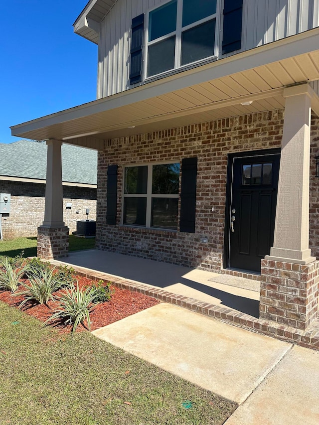 view of exterior entry featuring covered porch