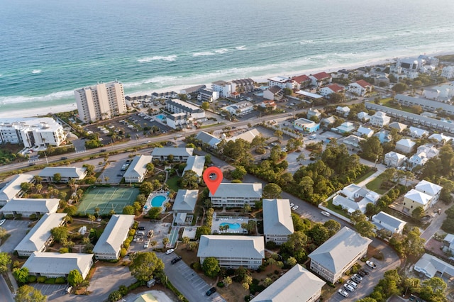 drone / aerial view featuring a water view and a view of the beach