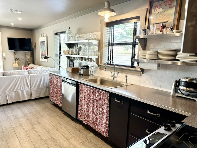 kitchen with dishwasher, sink, hanging light fixtures, backsplash, and light wood-type flooring