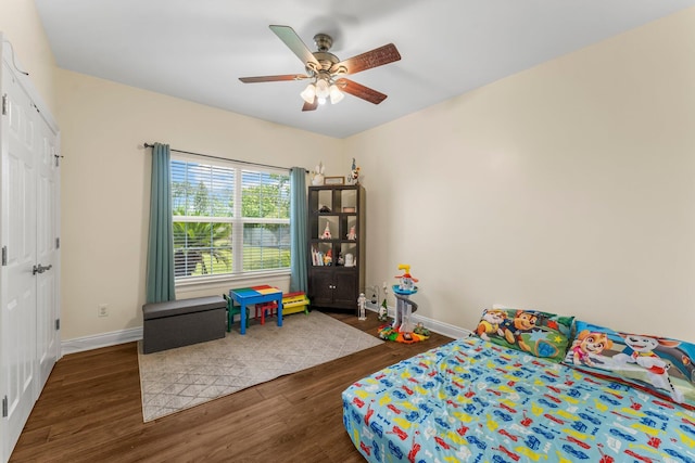 bedroom with ceiling fan and dark wood-type flooring