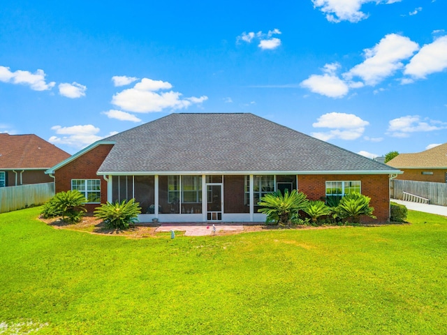 back of house featuring a sunroom and a yard