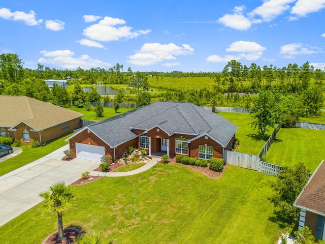 ranch-style house featuring a water view, a garage, and a front lawn