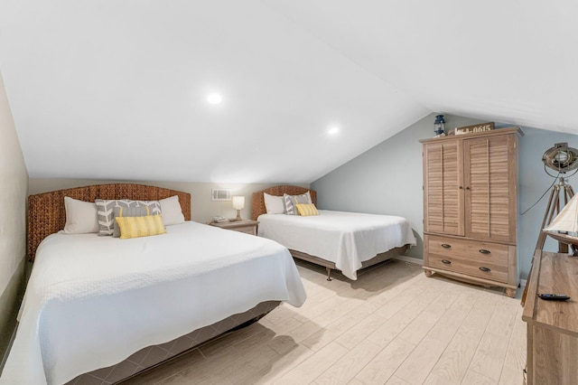 bedroom with lofted ceiling and light hardwood / wood-style flooring