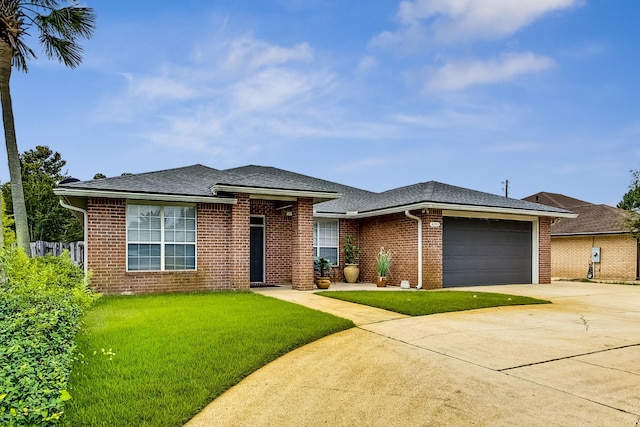 view of front of property with a front yard and a garage