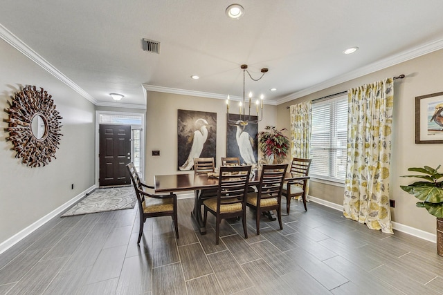 dining space featuring crown molding and an inviting chandelier