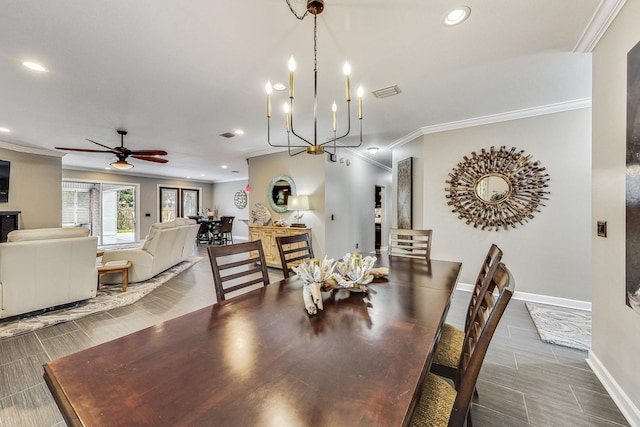 dining space with ceiling fan with notable chandelier and ornamental molding