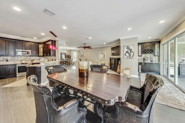 dining area featuring ceiling fan and ornamental molding