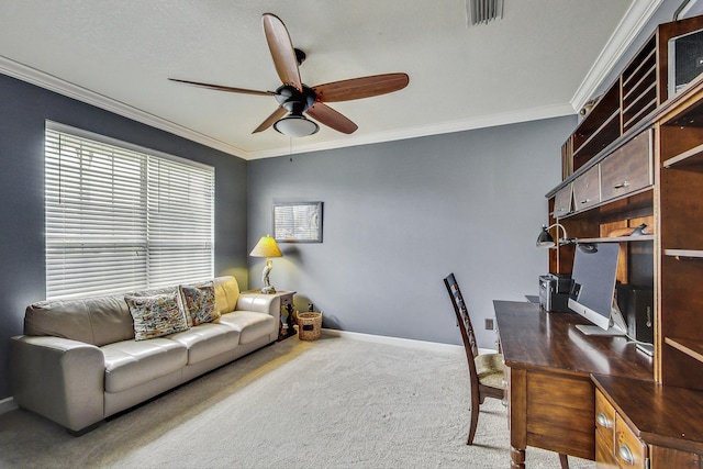 home office featuring carpet floors, ceiling fan, and crown molding