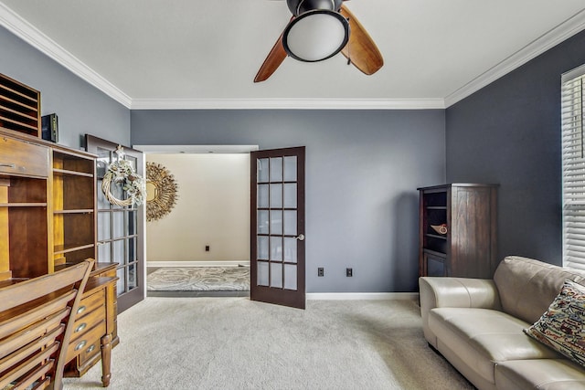 sitting room featuring light carpet, french doors, ceiling fan, and ornamental molding