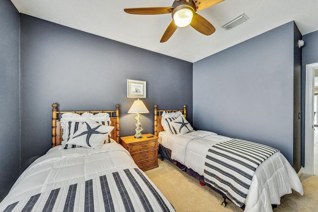 bedroom with ceiling fan and light carpet