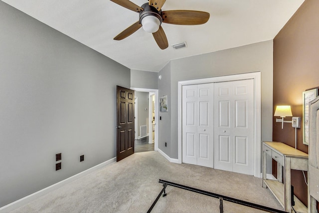 bedroom featuring ceiling fan, a closet, and light colored carpet