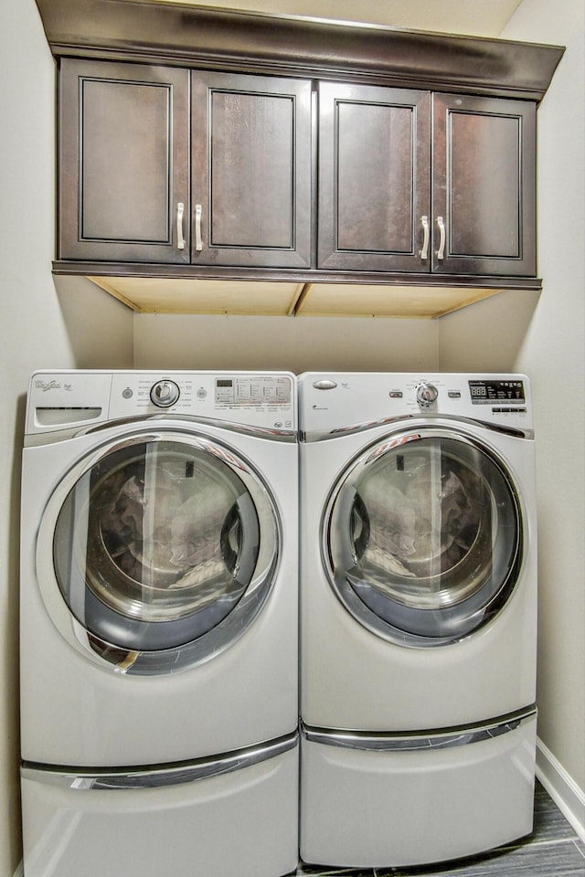 washroom featuring cabinets and independent washer and dryer