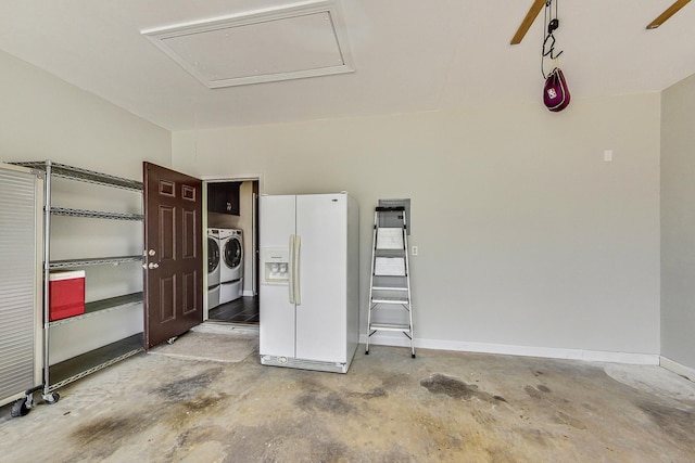 garage with white refrigerator with ice dispenser and washer and clothes dryer