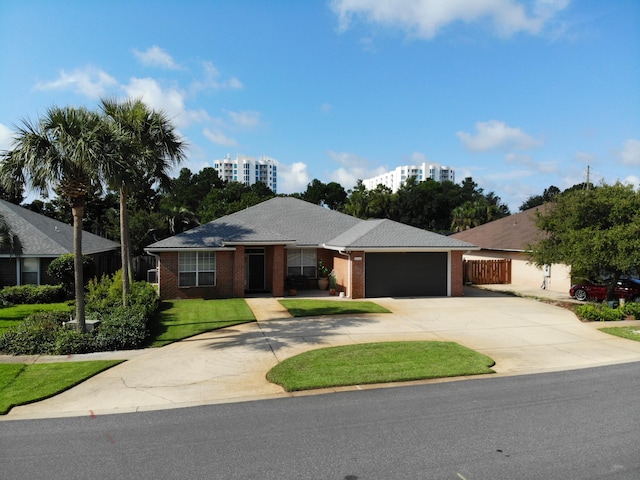 single story home with a front yard and a garage