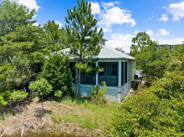 view of side of property featuring a sunroom