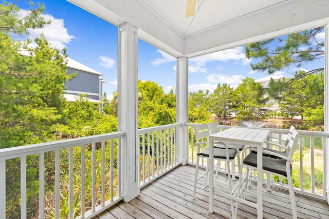 wooden terrace featuring ceiling fan