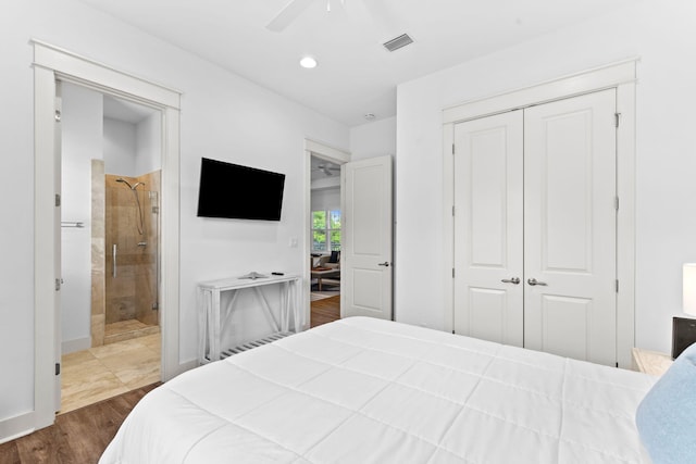 bedroom featuring ceiling fan, dark hardwood / wood-style floors, connected bathroom, and a closet