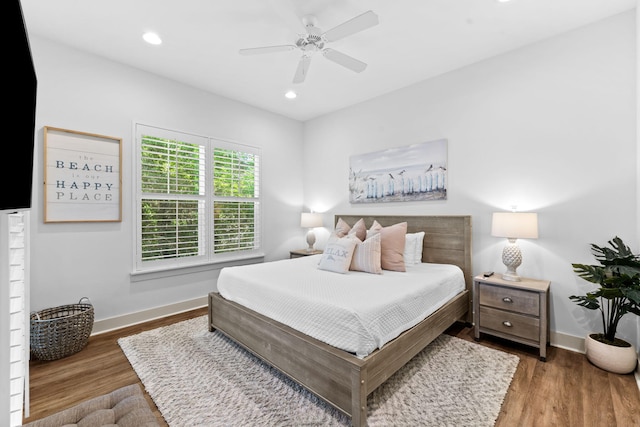 bedroom with ceiling fan and dark hardwood / wood-style floors