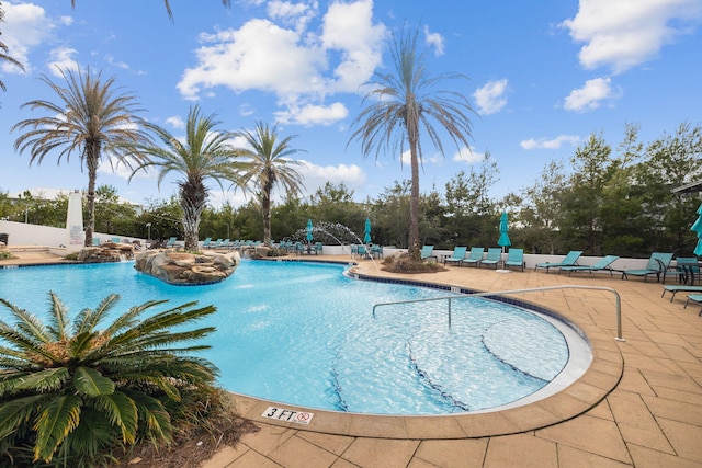 view of pool featuring pool water feature and a patio area