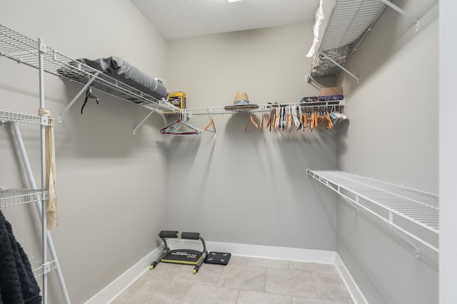 spacious closet featuring light tile patterned flooring