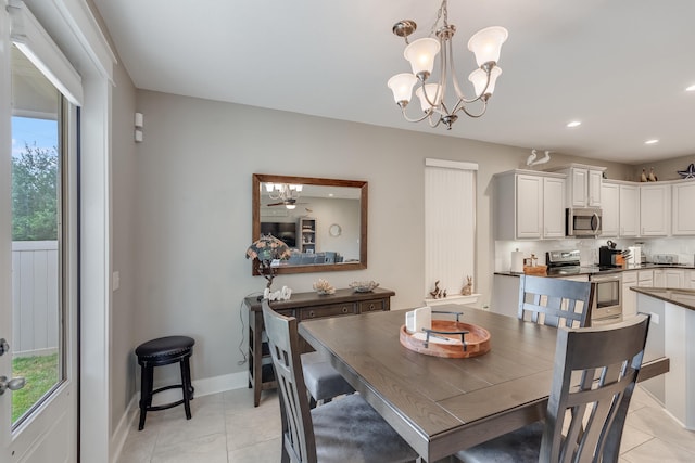 dining room featuring light tile patterned floors and ceiling fan with notable chandelier