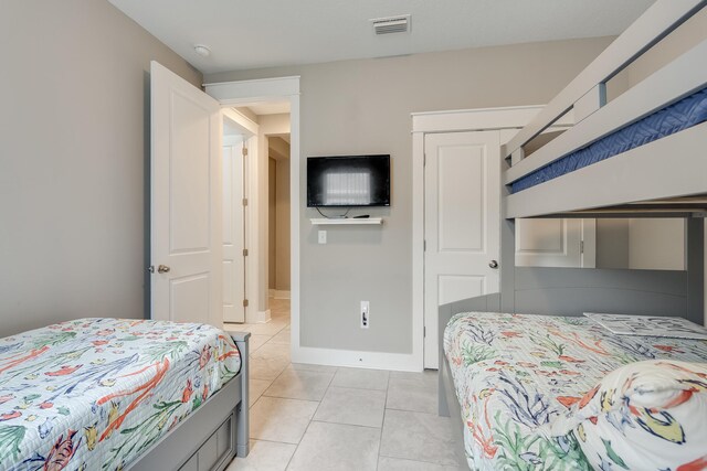 tiled bedroom featuring a closet