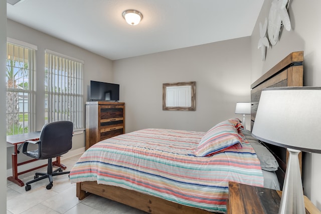 tiled bedroom with multiple windows