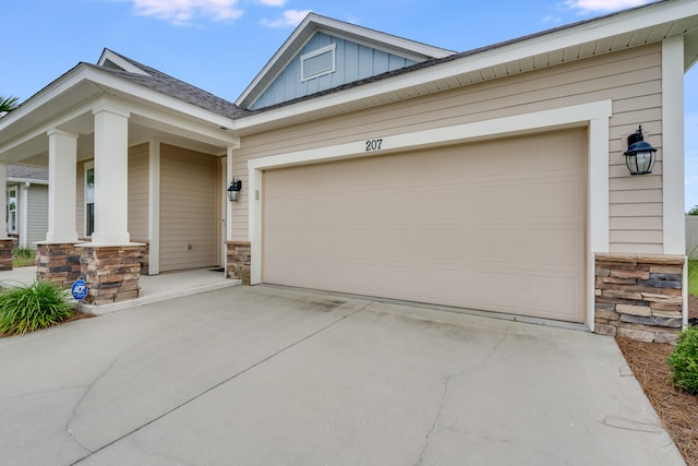 view of front of property featuring covered porch and a garage