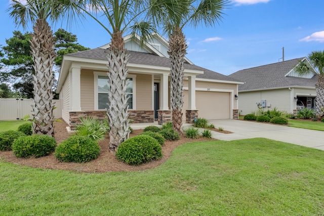 view of front of property featuring a front yard, a porch, and a garage