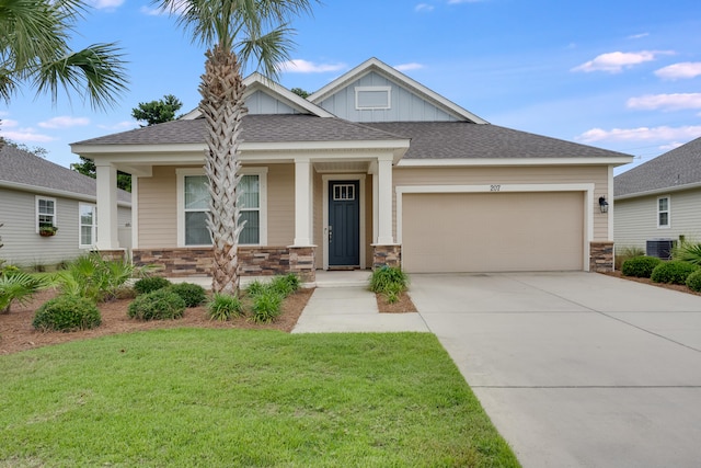 craftsman inspired home with a garage, a front lawn, and cooling unit