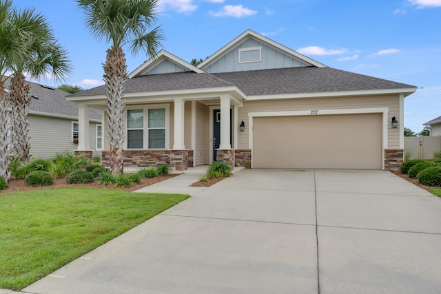 craftsman inspired home with a front yard and a garage