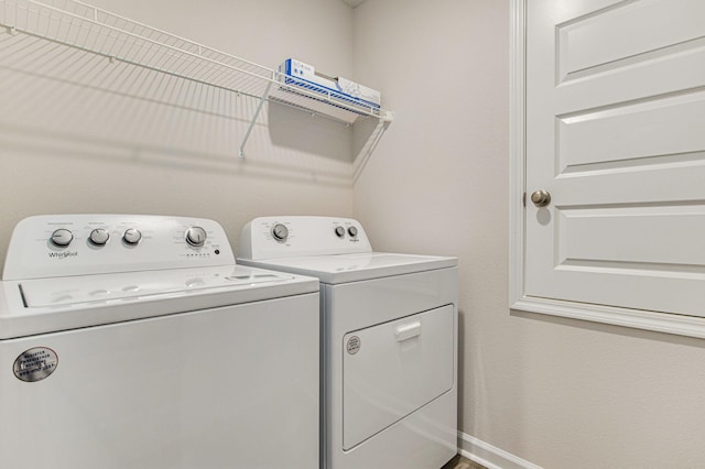 laundry room featuring laundry area, washer and clothes dryer, and baseboards