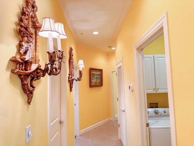 hallway featuring crown molding, baseboards, light tile patterned floors, recessed lighting, and washer / clothes dryer