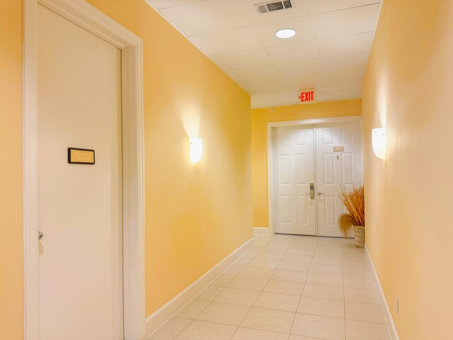 hall featuring light tile patterned flooring