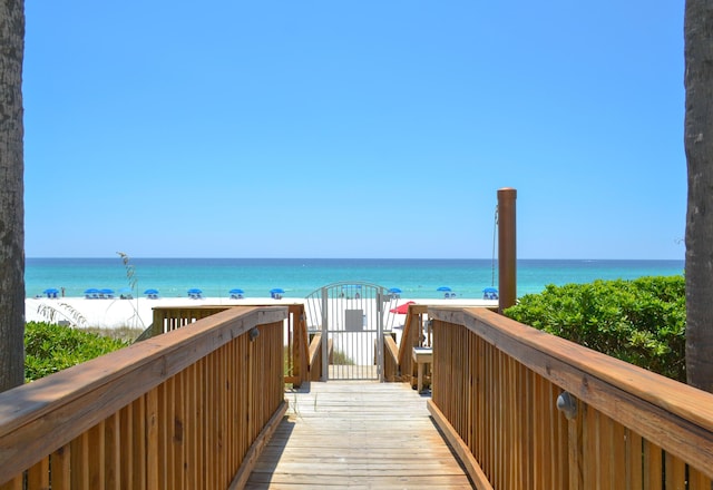 view of property's community with a beach view and a water view