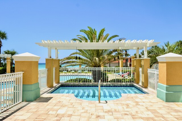 view of swimming pool featuring a water view and a patio