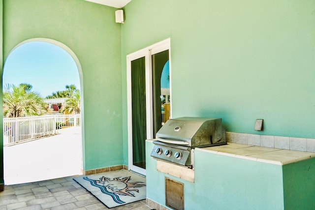 view of patio / terrace featuring an outdoor kitchen, fence, and grilling area