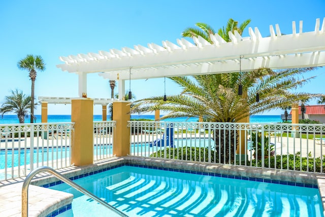 view of pool featuring a pergola, a water view, and fence